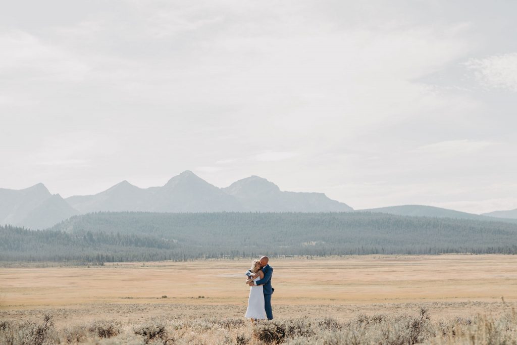 A bride and groom having their first look before their elopement in the Sawtooth Mountains.