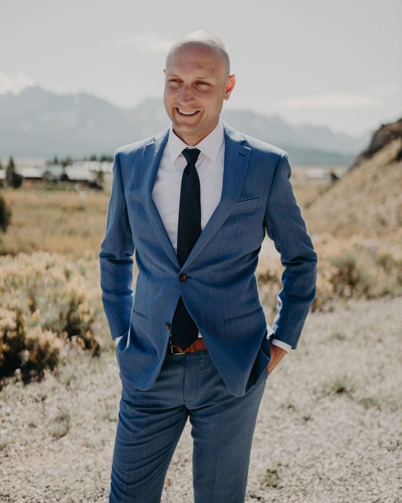 A groom getting ready before his elopement in the Sawtooth Mountains.