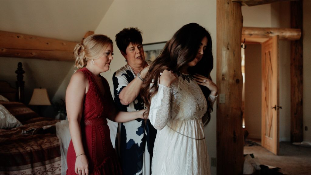 A bride putting on her dress before her wedding at the Hideout in Kirkwood.