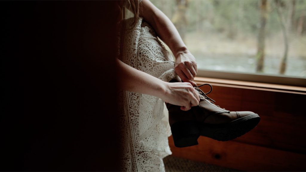 A bride putting on hiking boots before her Mt Hood elopement.