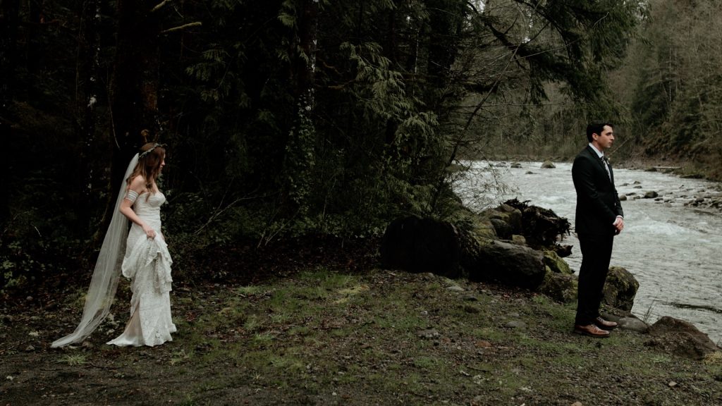 A bride and groom having their first look along the Salmon River before their Mt Hood elopement.