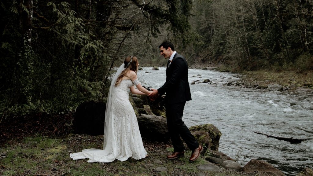 A bride and groom having their first look along the Salmon River before their Mt Hood elopement.