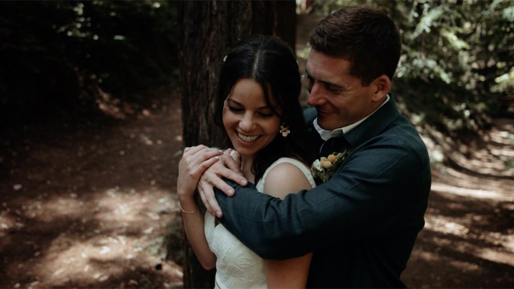A bride and groom in the redwoods on their wedding day.