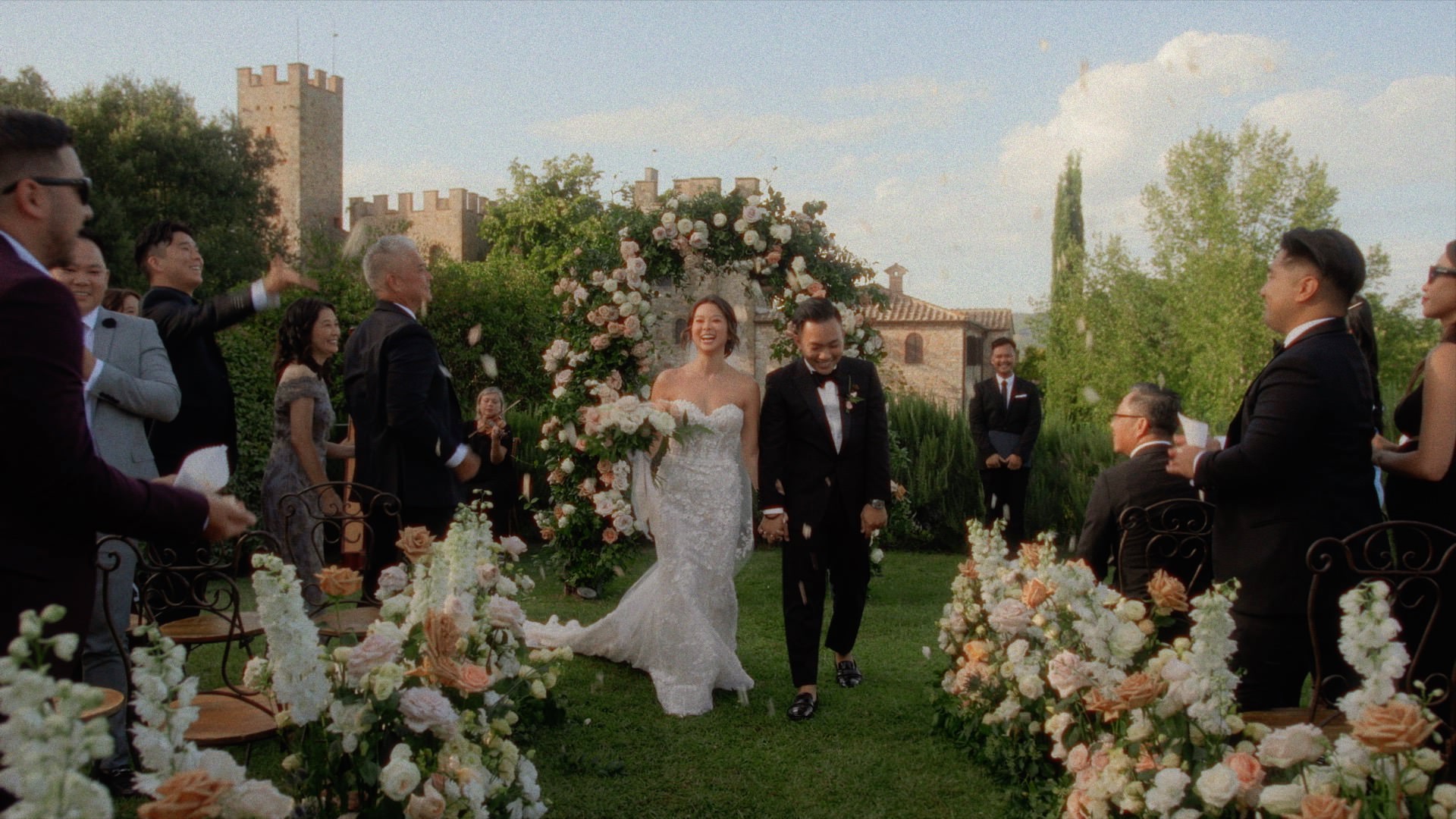 a couple walking down the aisle together at Castello di Montalto in Tuscany