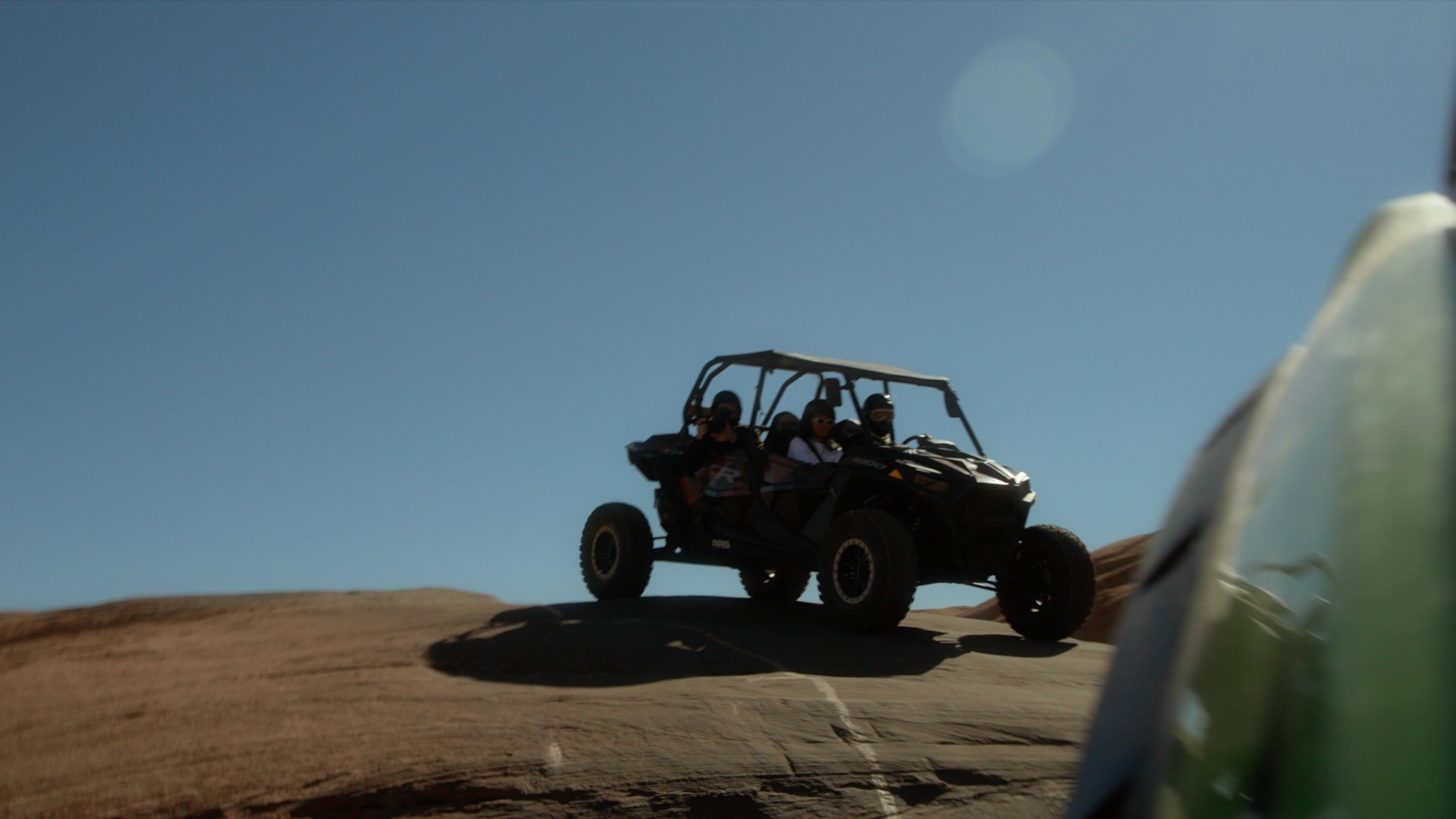 atvs driving through a trail in moab