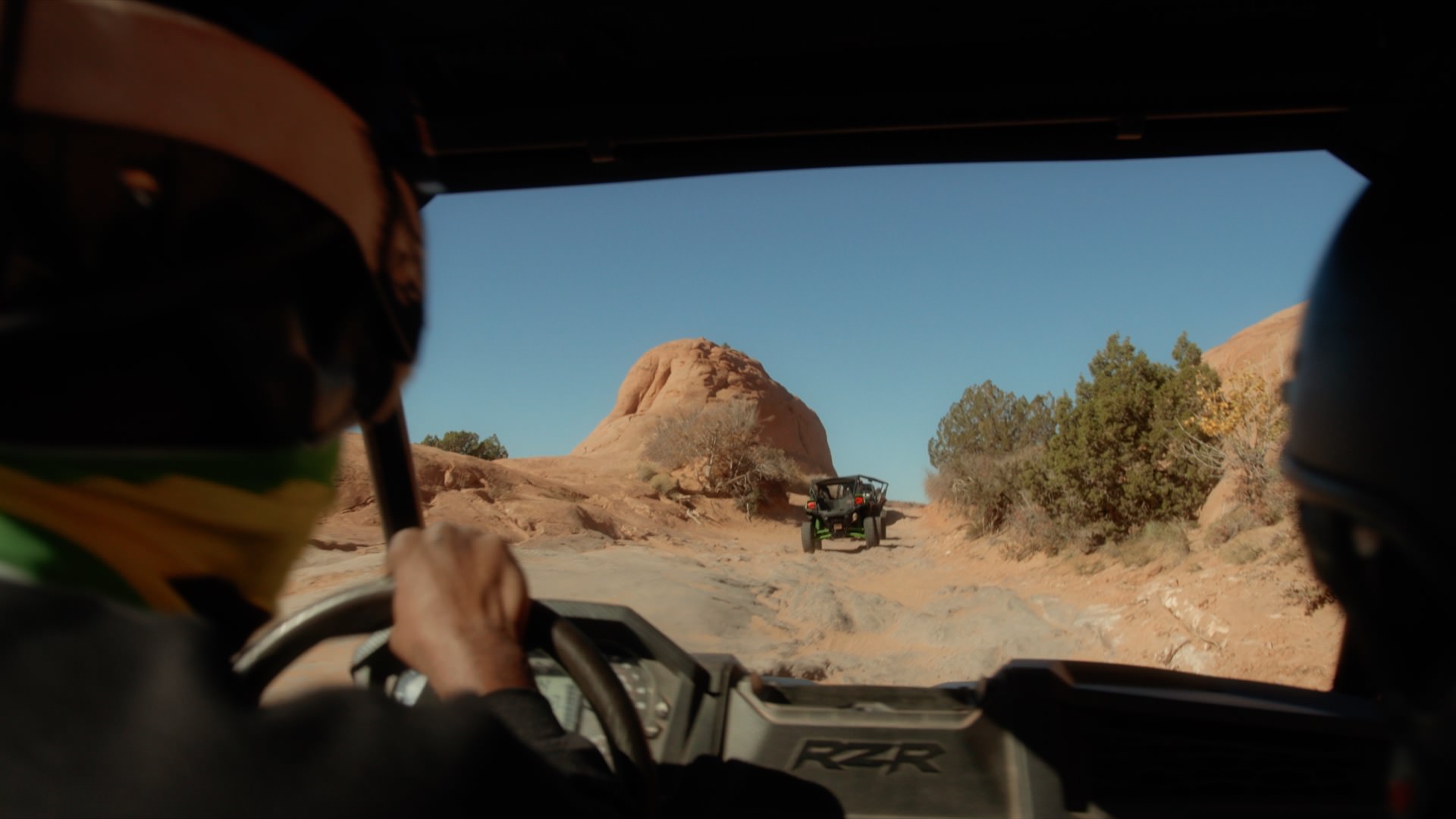 atvs driving through a trail in moab