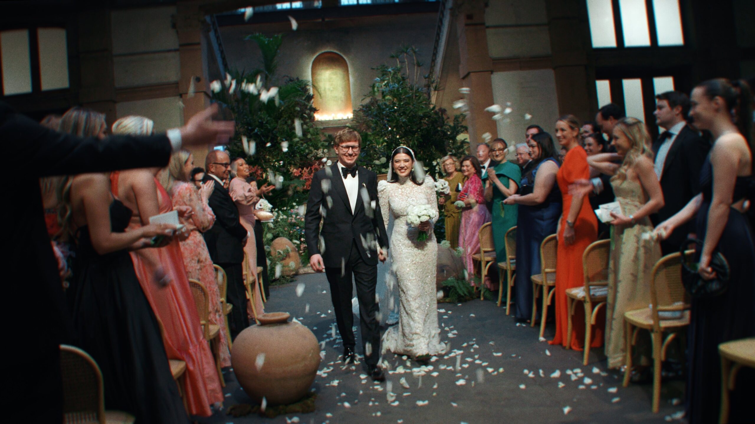 a bride and groom walking down the aisle